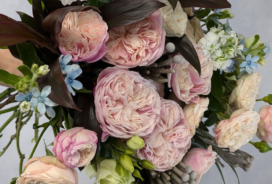A rich and luxurious combination of peach, pink and purple flowers, hand tied into a large bouquet including scented lilies and textured greenery.  